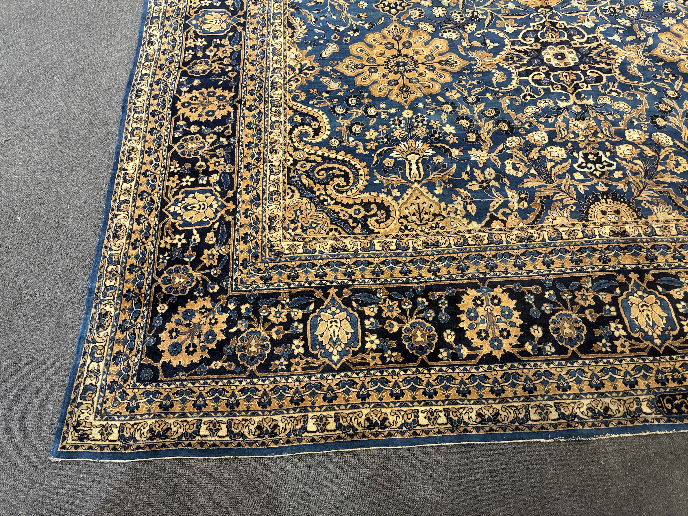 An early 20th century Kirman blue ground carpet, 425 x 325cm